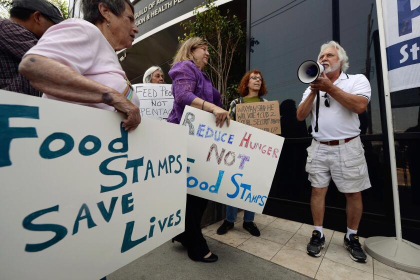 The House farm bill threatens $20.5 billion in cuts over a decade to food stamps. Above: Tom Camarello with Progressive Democrats of America and members from several other organizations hold a rally in front of Rep. Henry Waxman's office in Los Angeles.