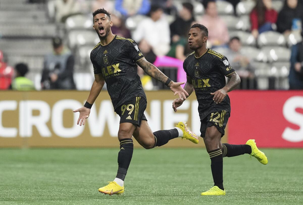 LAFC's Denis Bouanga and Diego Palacios celebrate Bouanga's first goal against the Vancouver Whitecaps.