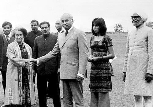 Benazir Bhutto is shown in 1972 standing next to her father and Pakistani President Zulfikar Ali Bhutto as he shakes hands with Indian Prime Minister Indira Gandhi in Simla, India.