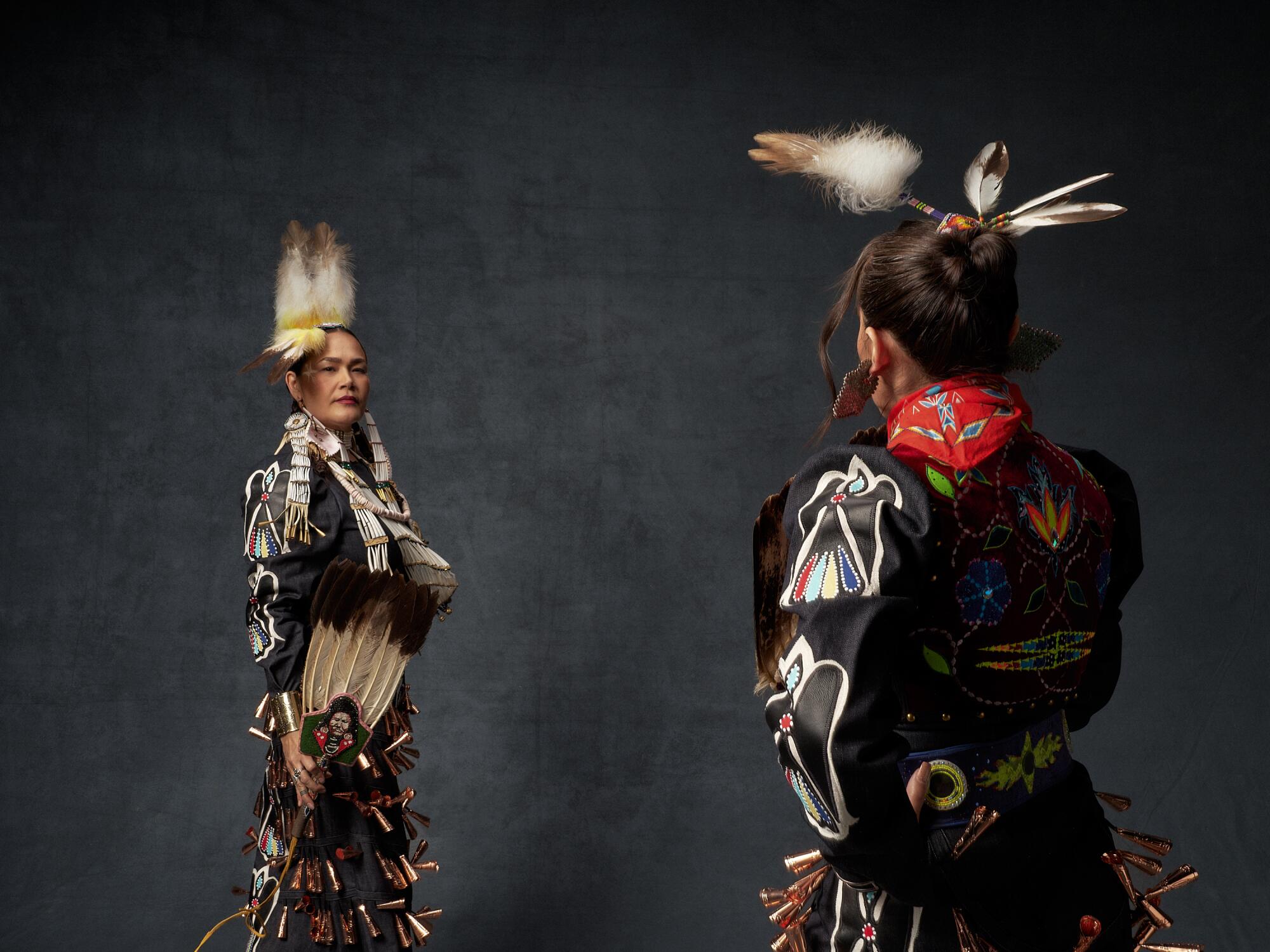 Two Native women in traditional wear.