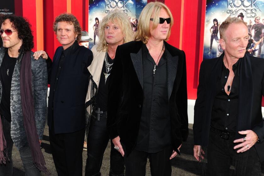 (FILES) In this June 8, 2012 file photo, L-R: Musicians Vivian Campbell, Rick Allen, Rick Savage, Joe Elliott and Phil Collen of Def Leppard arrive for the world premiere of the film "Rock of Ages" in Hollywood, California. Guitarist Vivian Campbell announced via Facebook June 20, 2015 he is pulling out of the rock band's tour after his cancer returned. Campbell, 52, announced two years ago that he was getting chemotherapy for Hodgkin lymphoma, which affects the lymphatic system. AFP PHOTO/Frederic J. BROWNFREDERIC J. BROWN/AFP/Getty Images ORG XMIT: -