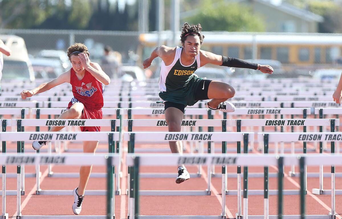 Edison's Cole Koffler clears a hurdle near the finish line to win the 110-meter high hurdles during the Surf League dual meet against Los Alamitos on Wednesday.