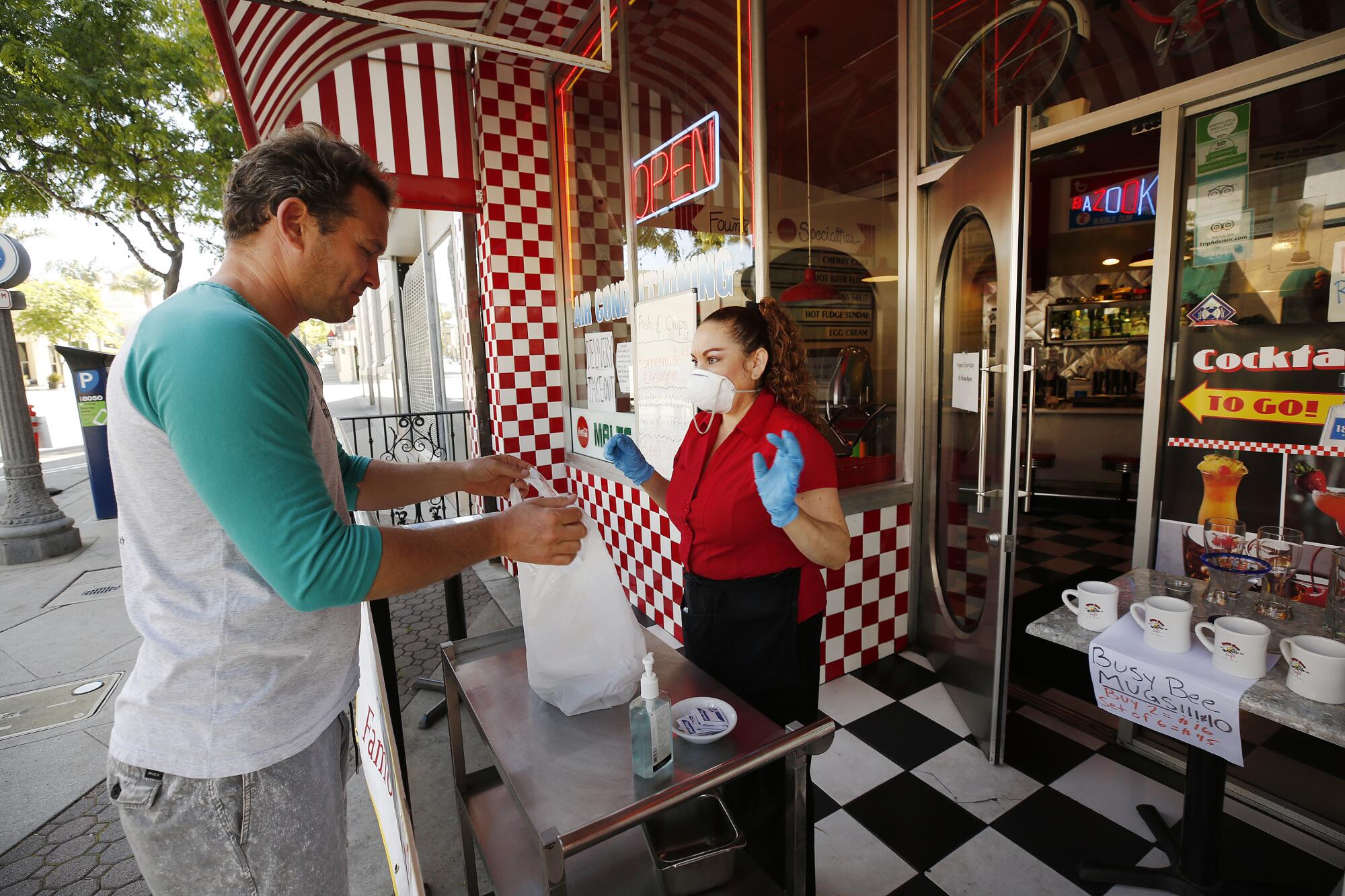 Yoeli Barag buys breakfast from Nora Nancy at Busy Bee Diner in Ventura on Wednesday.