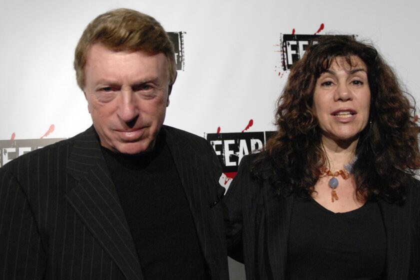 File-This Oct. 30, 2006, file photo shows writer, director Larry Cohen, left, and wife Cynthia Cohen arriving for the Comcast, Sony and Lionsgate launch party for FEARnet, a multi-platform network dedicated to horror, held at the Boulevard 3 nightclub in Los Angeles. Cohen, the maverick B-movie director of cult horror films "It's Alive" and "God Told Me To," has died. He was 77. Cohen's friend and spokesman, the actor Shade Rupe, said Cohen passed away Saturday, March 23, 2019, in Los Angeles surrounded by loved ones. (AP Photo/Phil McCarten, File)