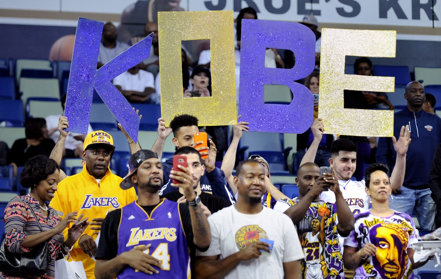 Fans hold a 'KOBE' sign as the Lakers take the court at Smoothie King Center in New Orleans.