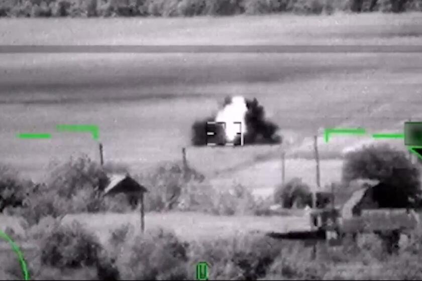 In this image from video, released by the Russian Defense Ministry Press Service on June 6, 2023, shows what Russia claimed was the destruction of a German-made Leopard tank. But a visual analysis by The Associated Press shows the grainy black-and-white video Russia released prove it had blown up the tanks actually documented the destruction of a tractor. Two experts, who watched the Russian video, both said the vehicle struck by the helicopter's missile was not a Leopard tank, or any other type of armored vehicle. Valentin Ch?telet, a research associate at The Atlantic Council's Digital Forensic Research Lab, also said the objects in the video were clearly not Leopard tanks.(Russian Defense Ministry Press Service via AP)