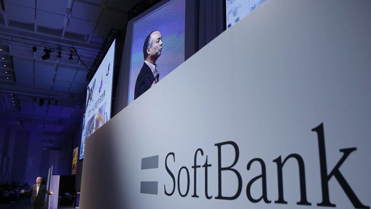 SoftBank Group Corp. Chief Executive Officer Masayoshi Son, left, speaks during a SoftBank World presentation at a hotel in Tokyo in July 2017.