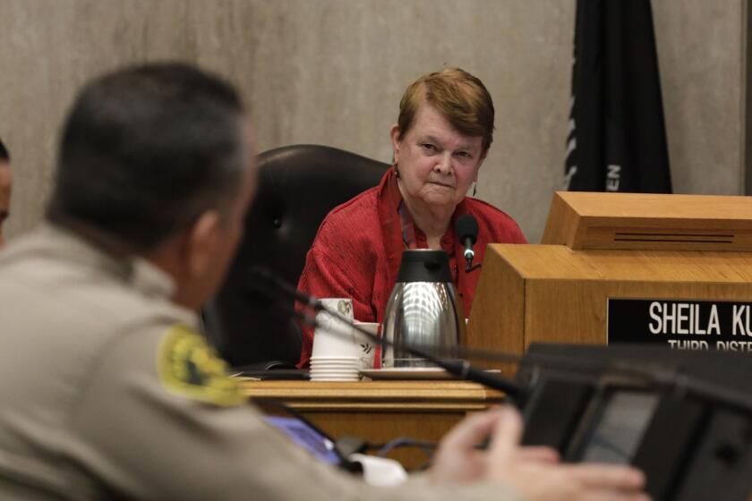LOS ANGELES, CA-JANUARY 29, 2019: LA County Board of Supervisors member Sheila Kuehl listens as Los Angeles County Sheriff Alex Villanueva speaks in front of LA County Board of Supervisors about his controversial reinstatement of a deputy who had served as his campaign aide and who had been fired in connection with allegations of domestic violence. Supervisors Sheila Kuehl and Kathryn Barger created a motion to challenge the reinstatement and ask county counsel how they can navigate conflicts with the sheriff, including possibly withholding pay from a deputy. (Katie Falkenberg / Los Angeles Times)
