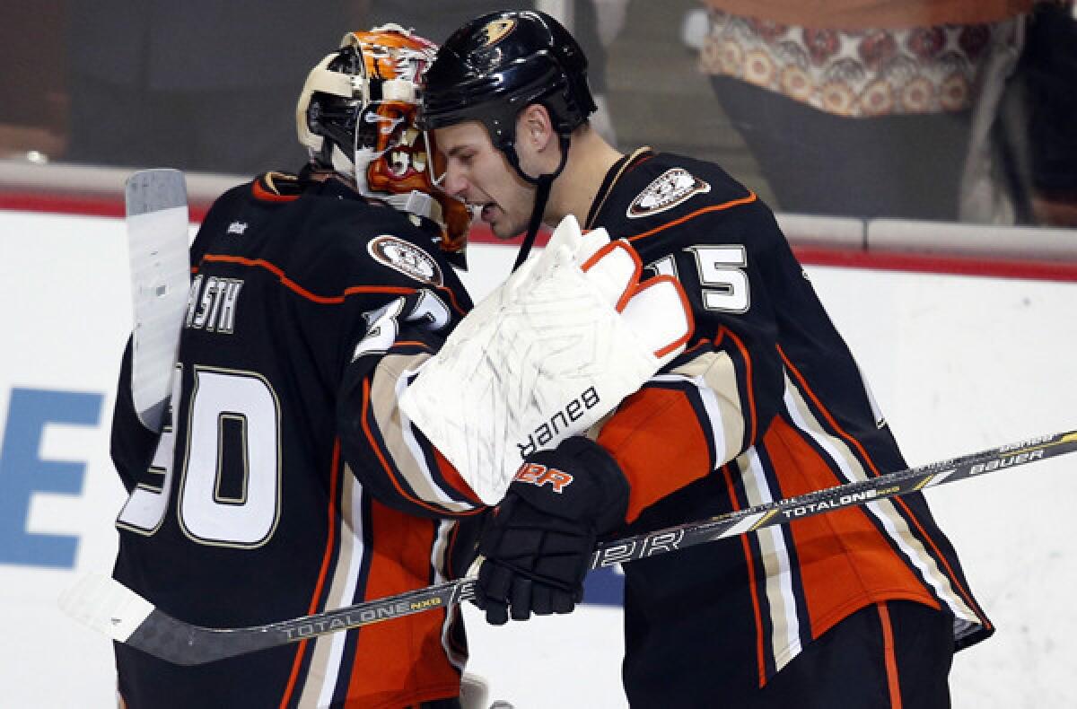 Captain Ryan Getzlaf (15) congratulates goaltender Viktor Fasth after the Ducks defeated the Flames, 4-0, on Friday night.