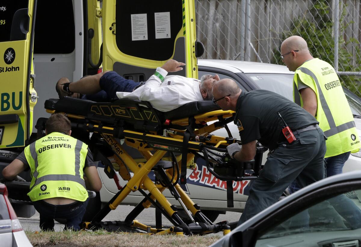 Ambulance staff take a man from outside a mosque in central Christchurch, New Zealand, Friday, March 15, 2019. A witness says many people have been killed in a mass shooting at a mosque in the New Zealand city of Christchurch.