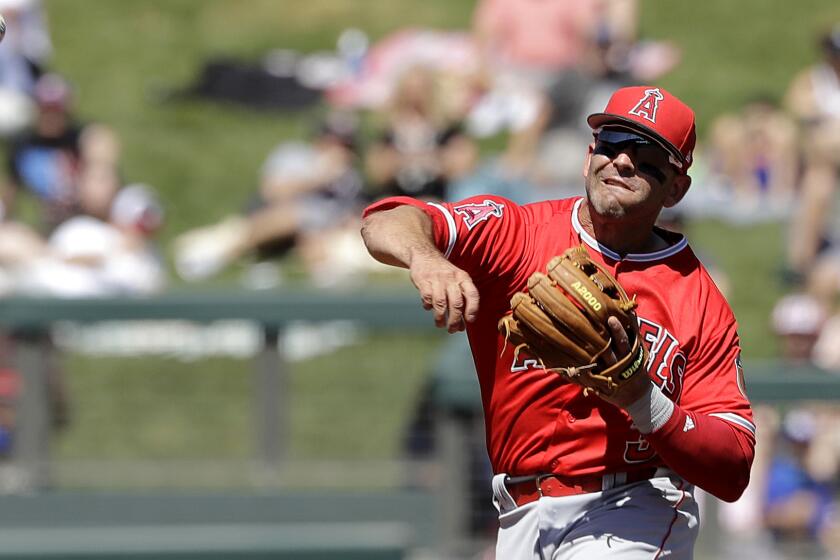 Angels second baseman Danny Espinosa throws to first base for an out during the second inning against the Rockies on Thursday.