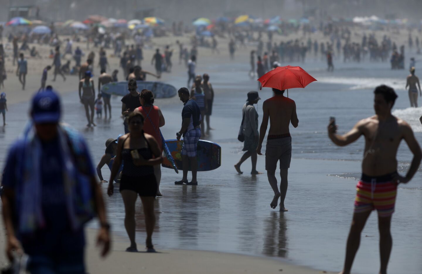 Visitors cool off in the surf in Santa Monica.