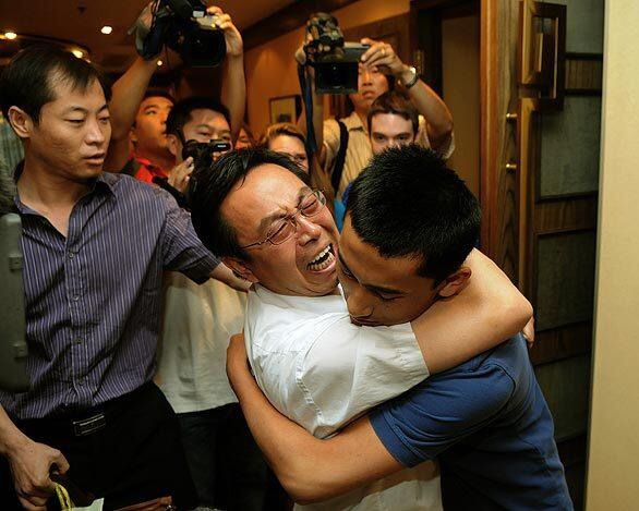 Jin Gaoke hugs his son, now Christian Norris, in Beijing. Norris was born Jin Jiacheng in 1991 in Yinchuan, west of Beijing. Because his parents could have been penalized for having a second child, he was sent as a newborn to be raised by relatives. Later, he lived briefly with his birth parents and somehow got lost, his family says.