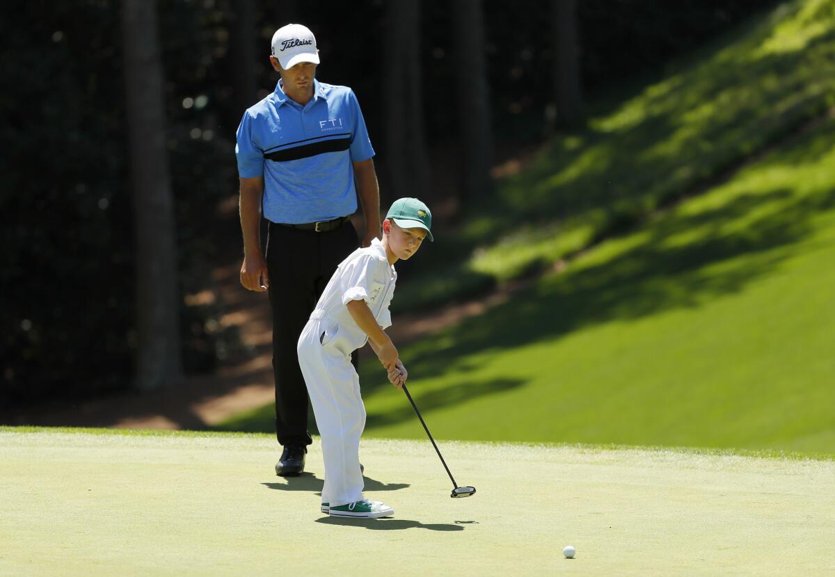 Charles Howell III watches son Chase putt during the Masters par-three contest.