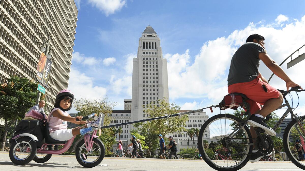 CicLAvia participants ride by City Hall in downtown Los Angeles on Sunday.