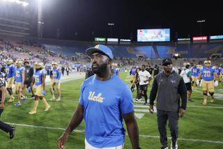 Pasadena, CA - September 14: UCLA head coach DeShaun Foster walks off the field.