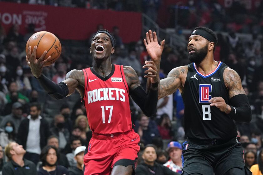 Houston Rockets guard Dennis Schroder, left shoots as Los Angeles Clippers forward Marcus Morris Sr. defends during the first half of an NBA basketball game Thursday, Feb. 17, 2022, in Los Angeles. (AP Photo/Mark J. Terrill)
