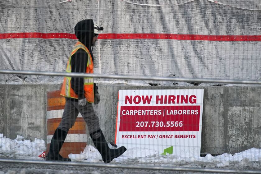 A worker passes a hiring sign at a construction site, Wednesday, Jan. 25, 2023, in Portland, Maine. On Thursday, the Labor Department reports on the number of people who applied for unemployment benefits last week. (AP Photo/Robert F. Bukaty)