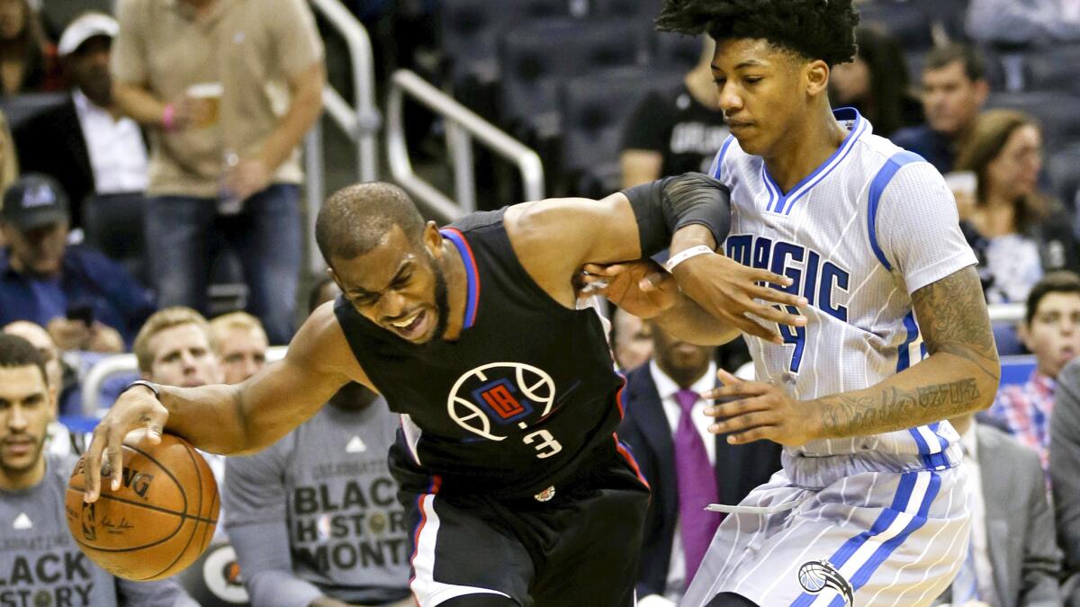 Clippers point guard Chris Paul tries to keep his balance as he drives against Magic guard Elfrid Payton during the first half Friday night in Orlando.