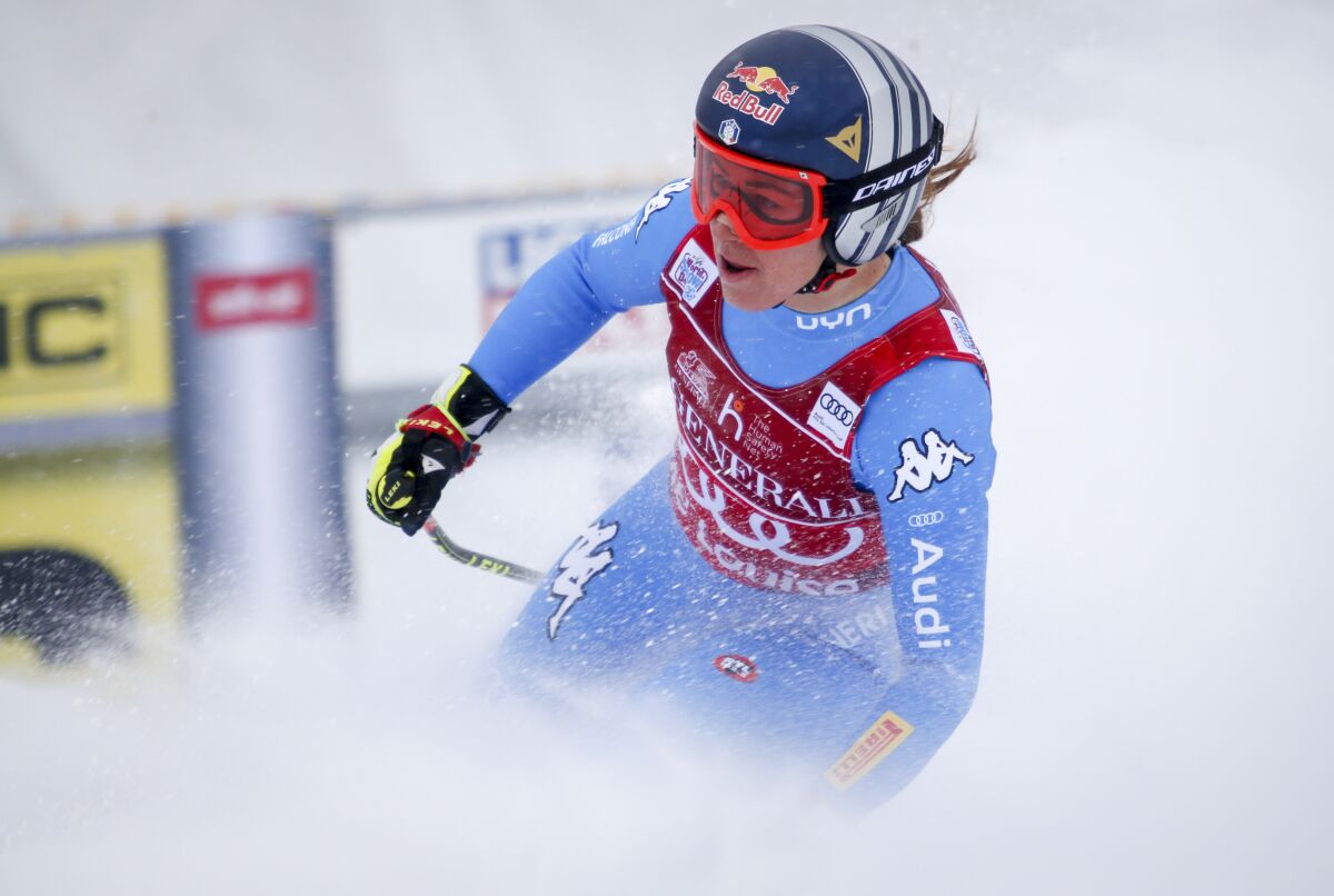 Italy's Sofia Goggia reacts in the finish area following her run in the the women's World Cup downhill ski race in Lake Louise, Alberta, on Saturday, Dec. 4, 2021. (Jeff McIntosh/The Canadian Press via AP)