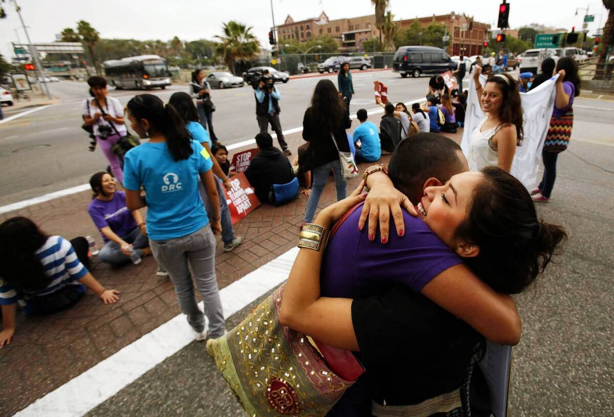 Nancy Guarneros, 25, right, hugs Jorge Gutierrez, 28, as they join more than 150 students and Dream Act supporters who rallied in downtown Los Angeles on Friday to voice support for President Obama's decision to halt the deportation of young illegal immigrants who have no criminal records and meet certain other criteria.