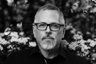 Jeff Vandermeer, with salt and pepper hair and trim beard in glasses and a dark shirt with flower blossoms behind him.