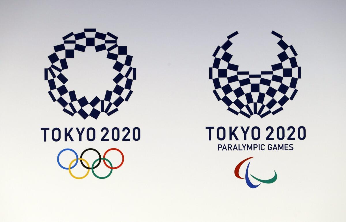 The Tokyo 2020 Olympic and Paralympic Games logos, created by Japanese artist Aso Tokolo, are displayed in Tokyo on Monday.