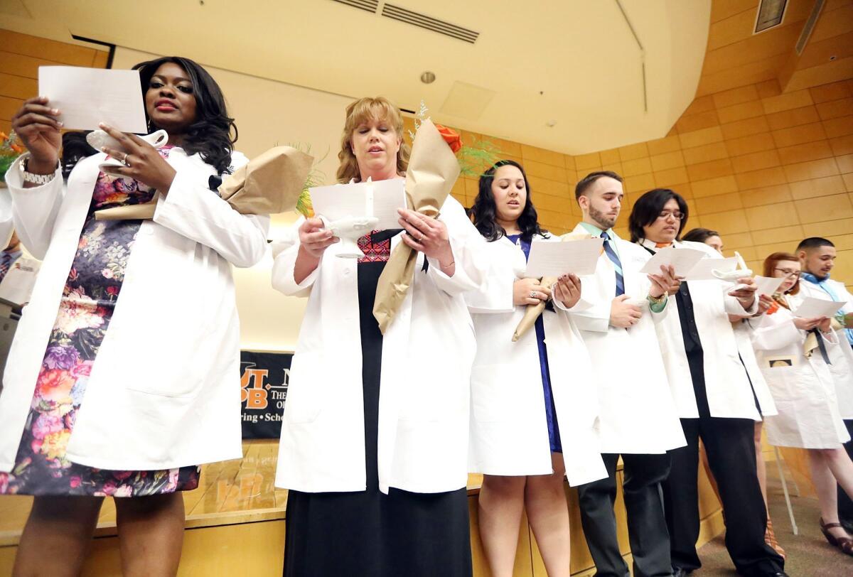 Graduating nursing students recite the Nightingale Pledge during a ceremony in 2015.