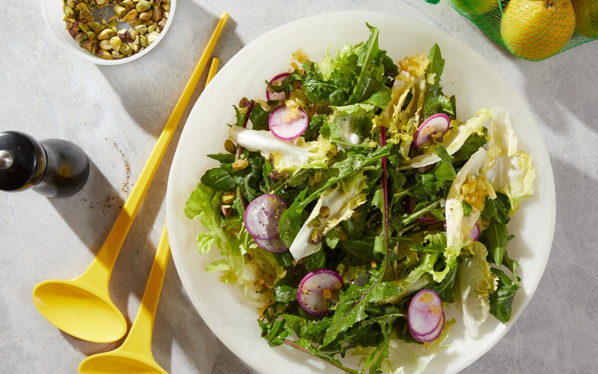 Sour and bright preserved lemon adds an intense zest to this salad of mature greens and creamy pistachios.
