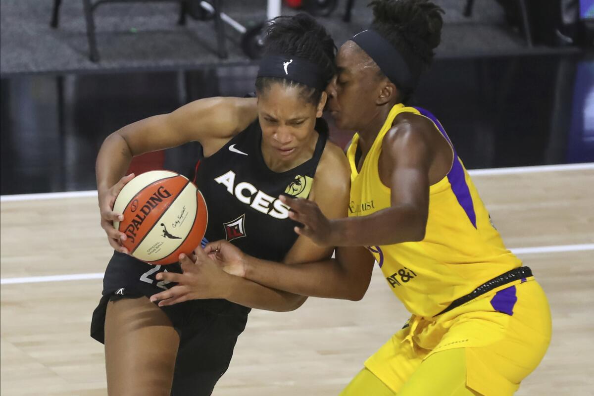 Aces center A'ja Wilson drives against Sparks forward Nneka Ogwumike during the first half of their game Sept. 12, 2020.