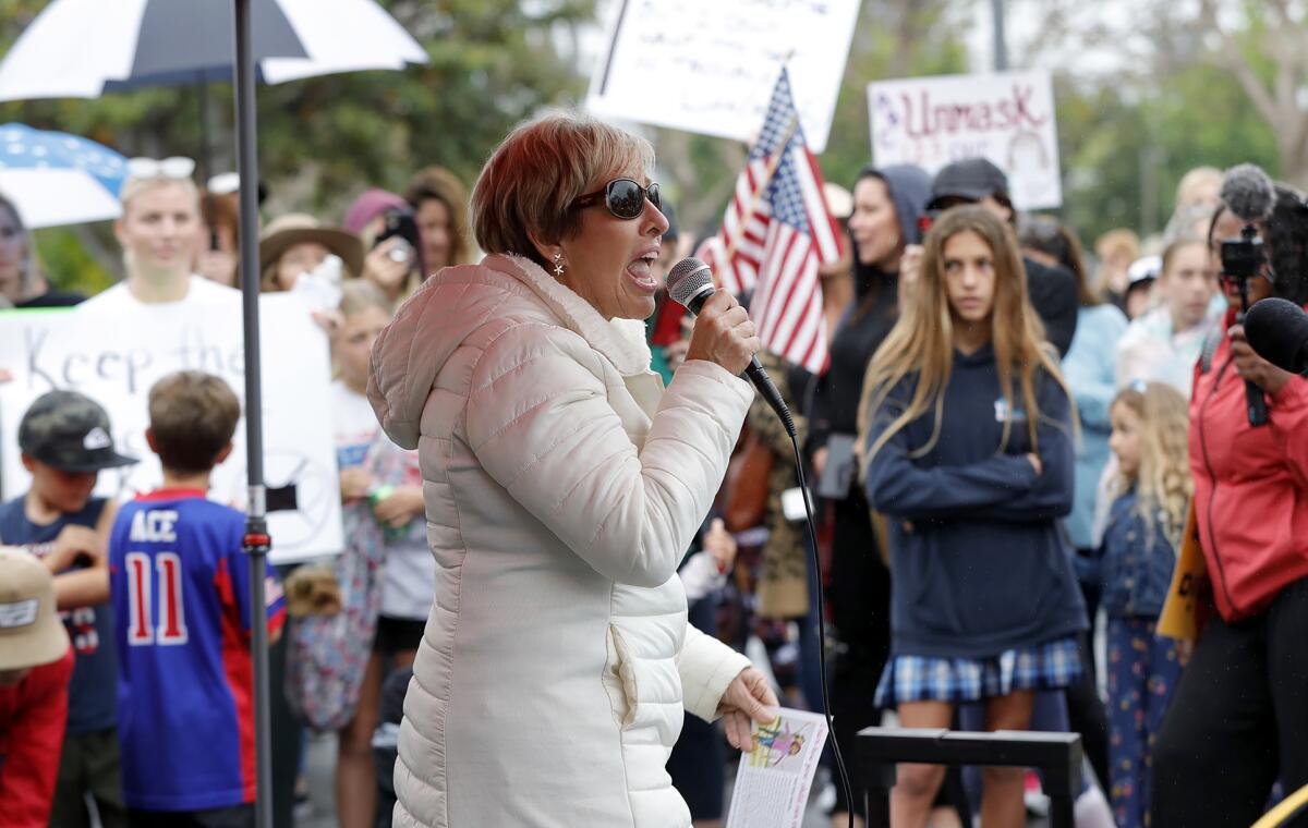 Orange County resident Peggy Hall urges parents in a rally in Costa Mesa Monday to send their kids to school without masks. 
