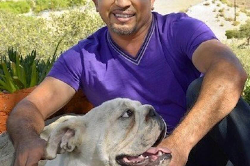Cesar Millan with his English bulldog George at Millan's Dog Psychology Center in Santa Clarita.