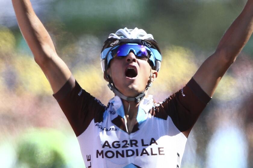 Alexis Vuillermoz celebrates as he crosses the finish line to win the eighth stage of the Tour de France on Saturday.