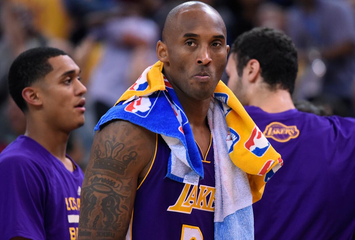 Lakers guard Kobe Bryant rests during a break in the game against the Warriors.