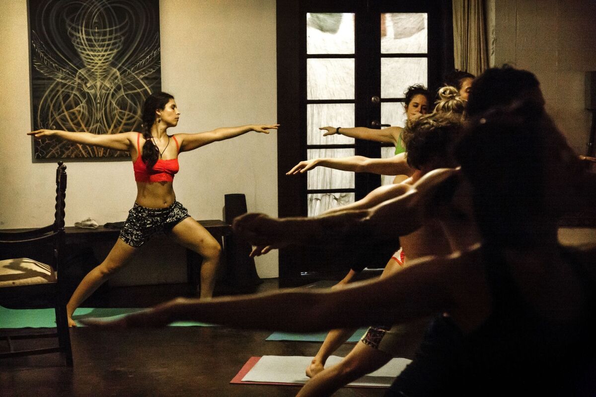 Odara Pi-eda, 28, left, stretches with others at the studio. "For downtown, Peace is like having the most amazing feng shui and not knowing where it comes from," says Santino Rice, a fashion designer and reality TV personality. "It is kind of an anchor for all the amazing energy that is going on on Spring Street."