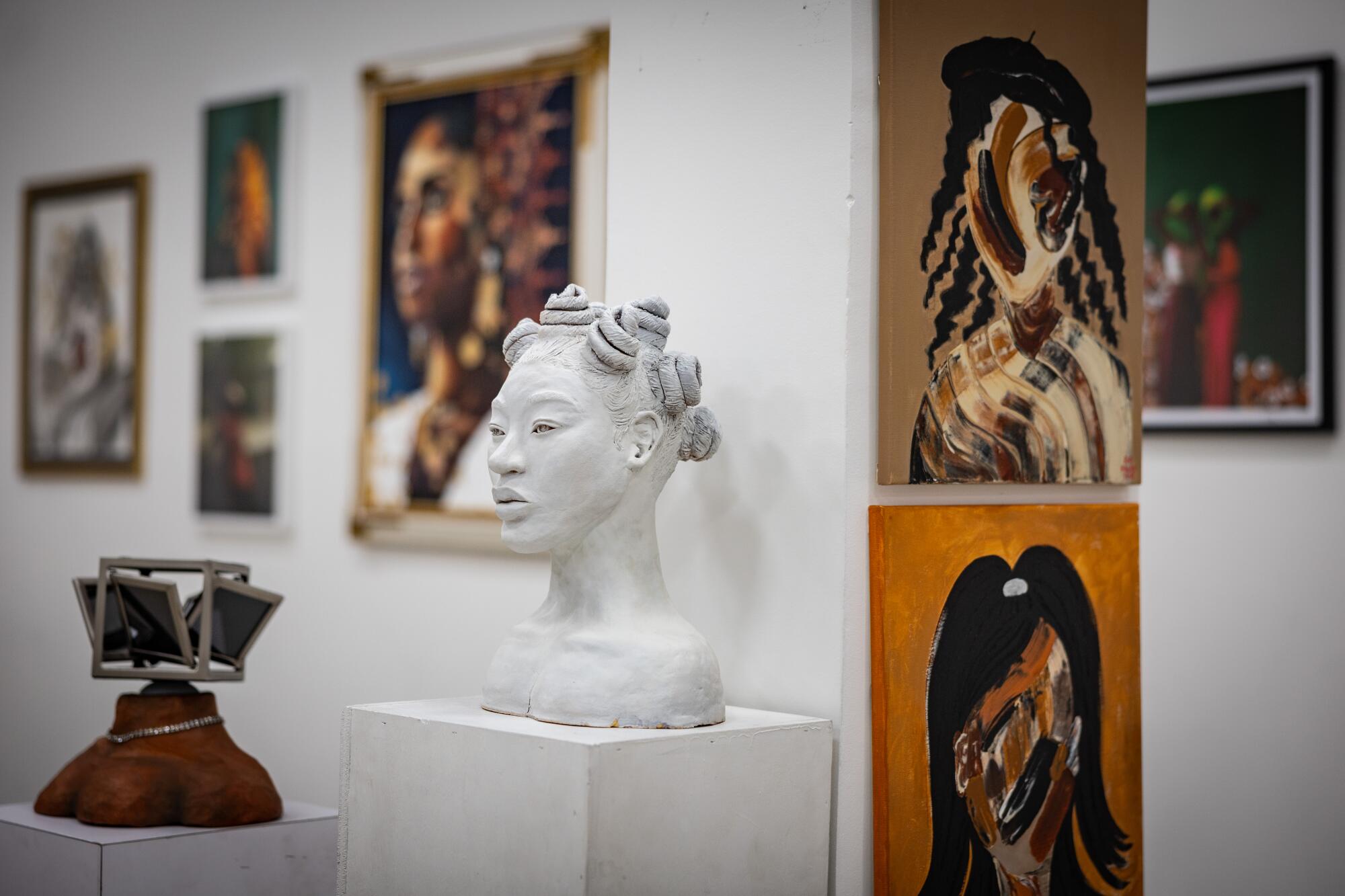 A sculpture of a Black woman's head titled "She" by Alé Reviere was selected for the exhibition.