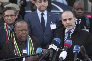 Accompanied with South Africa's Foreign Minister Naledi Pandor, left, Palestinian assistant Minister of Multilateral Affairs Ammar Hijazi addresses reporters after session of the International Court of Justice, or World Court, in The Hague, Netherlands, Friday, Jan. 26, 2024. The United Nations' top court has stopped short of ordering a cease-fire in Gaza in a genocide case but demanded that Israel try to contain death and damage in its military offensive in the tiny coastal enclave. South Africa brought the case and had asked the court to order Israel to halt its operation. (AP Photo/Patrick Post)