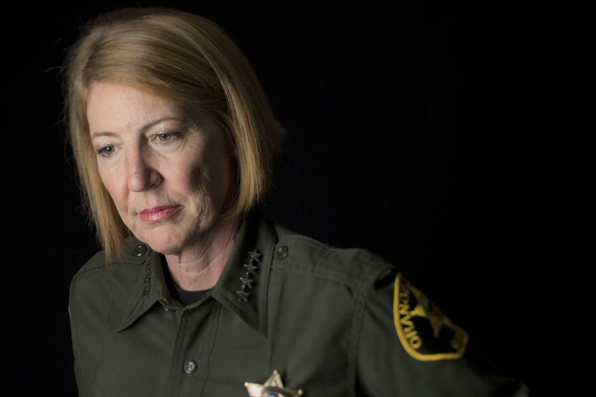 A portrait of Sandra Hutchens in uniform and badge.