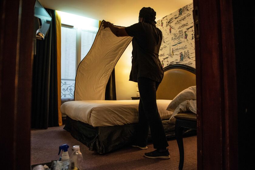A chambermaid makes up a room of a hotel in Paris on December 20, 2019. (Photo by Aurore MESENGE / AFP) (Photo by AURORE MESENGE/AFP via Getty Images)