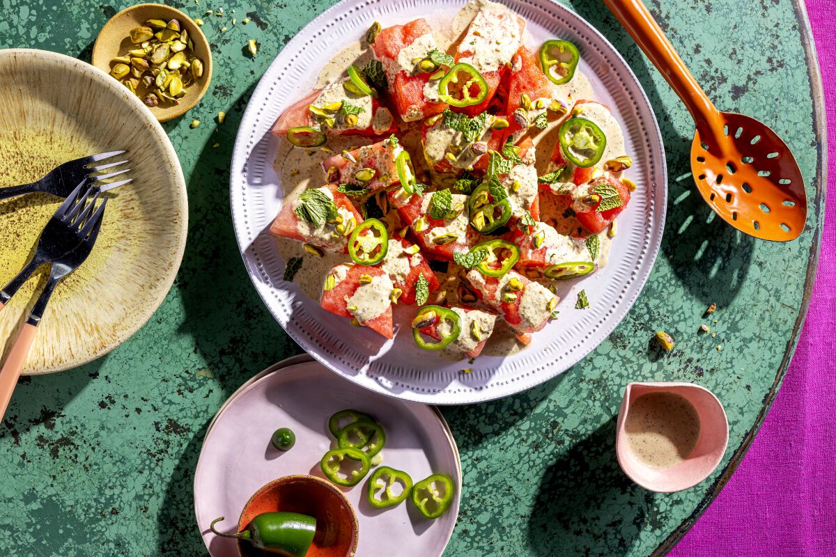 Spicy Watermelon Salad with Tahini, topped with sliced jalapenos and pistachios