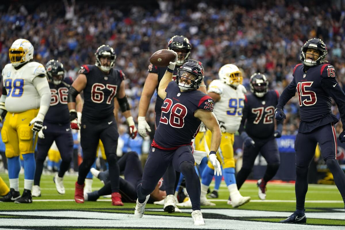 Houston Texans running back Rex Burkhead (28) celebrates after rushing for a touchdown against the Chargers on Sunday