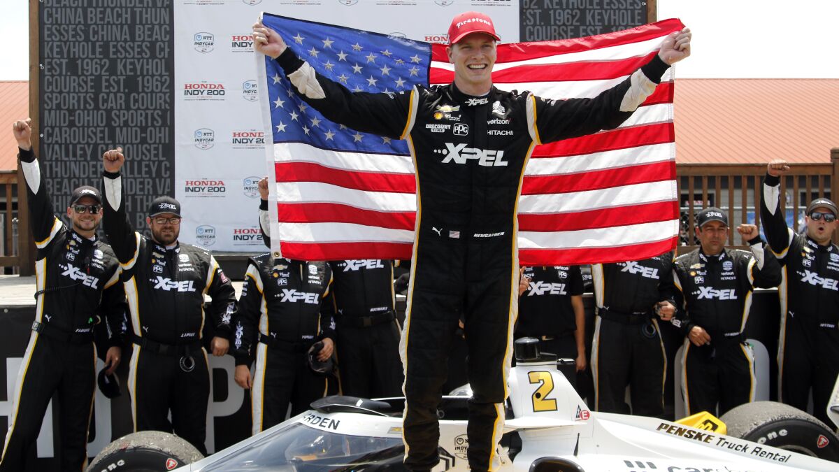 Josef Newgarden celebrates in victory lane after winning an IndyCar race at Mid-Ohio Sports Car Course in Lexington, Ohio, Sunday, July 4, 2021. (AP Photo/Tom E. Puskar)
