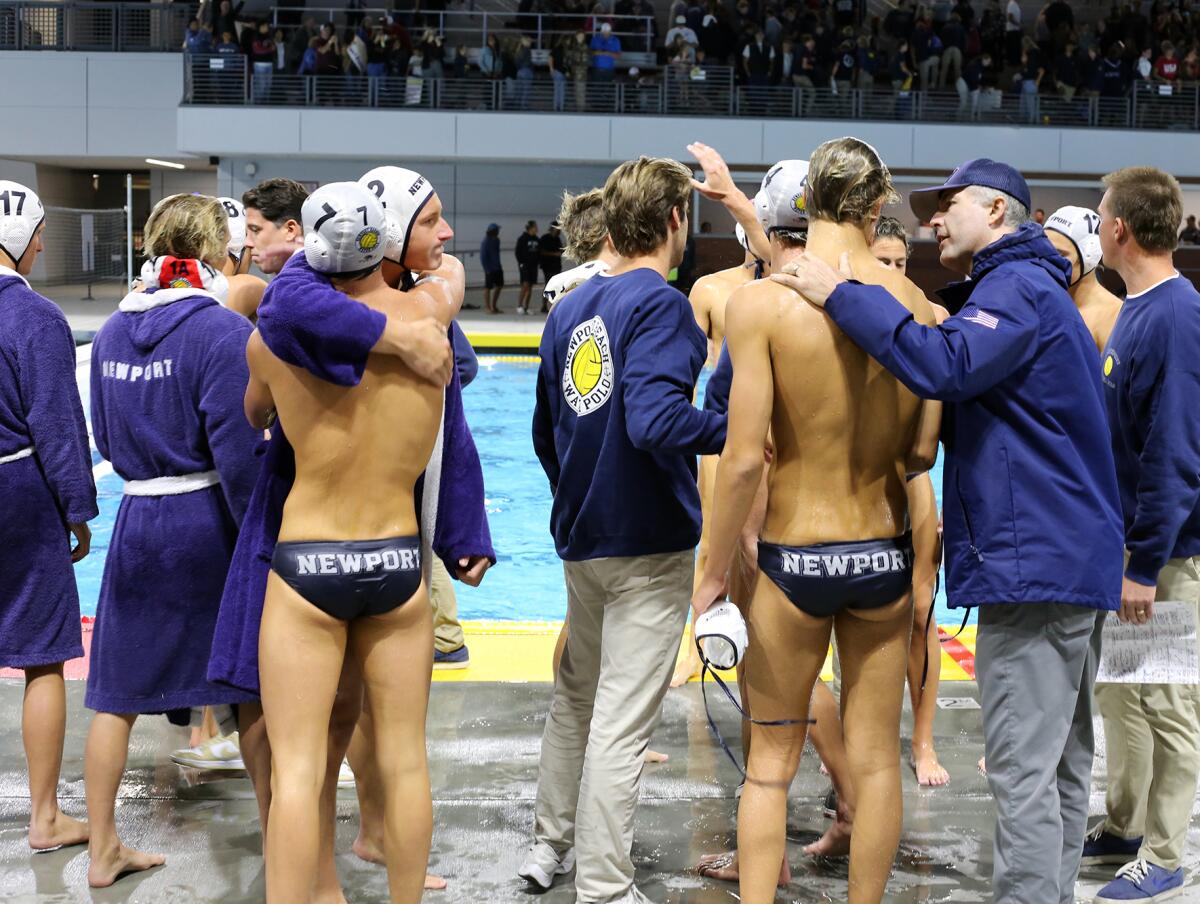 The Newport Harbor High boys' water polo team consoles each other after losing Saturday's