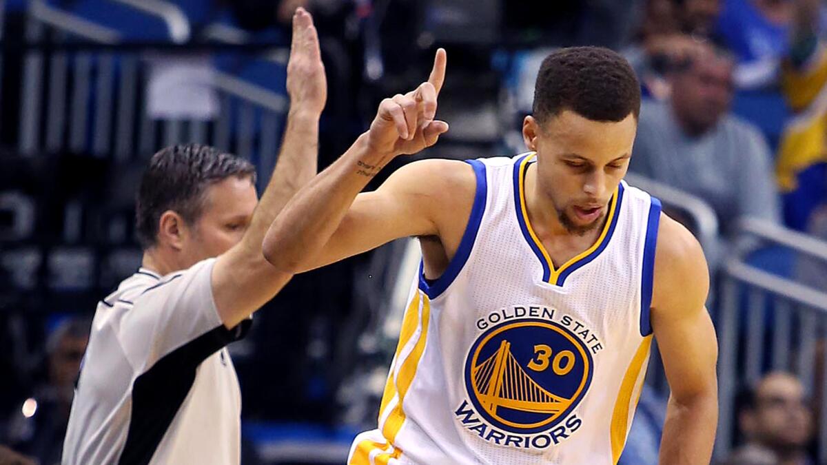 Warriors guard Stephen Curry celebrates after making a three-point shot against the Magic on Thursday night.