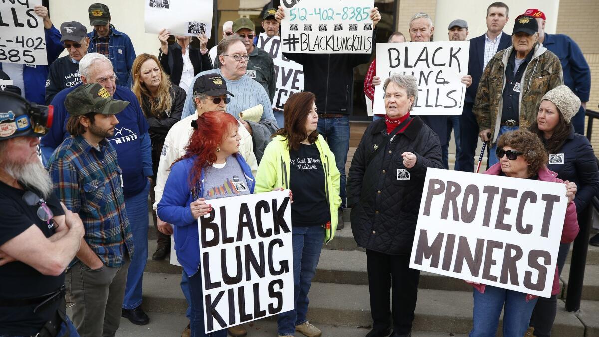 Coal mining advocates listen as Patty Amburgey of Letcher, Ky., speaks about the death of her husband from black lung disease during a protest near the office of Senate Majority Leader Mitch McConnell (R-Ky.) at the Laurel County Justice Center in London, Ky., Wednesday.