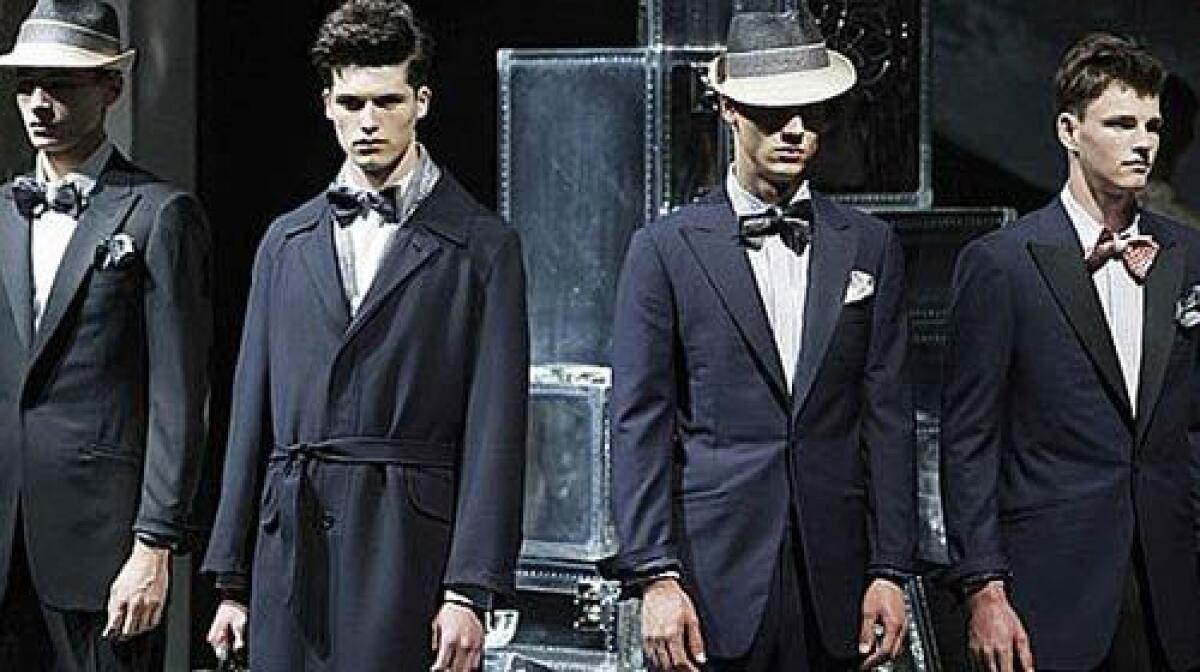 ALFRED DUNHILL: Dark blue suits and coats with shimmering elements add to the faded futurism theme.