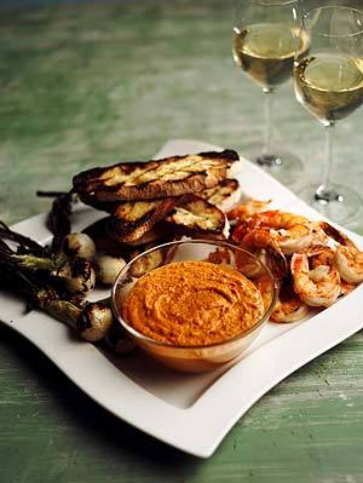Recipe: Romesco with grilled bread, spring onions and shrimp.