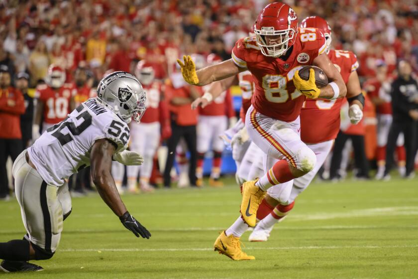 Las Vegas Raiders linebacker Denzel Perryman (52) misses the tackle on Kansas City Chiefs tight end Travis Kelce (87) as Kelce ran in for a touchdown during the second half of an NFL football game, Monday, Oct. 10, 2022 in Kansas City, Mo. (AP Photo/Reed Hoffmann)