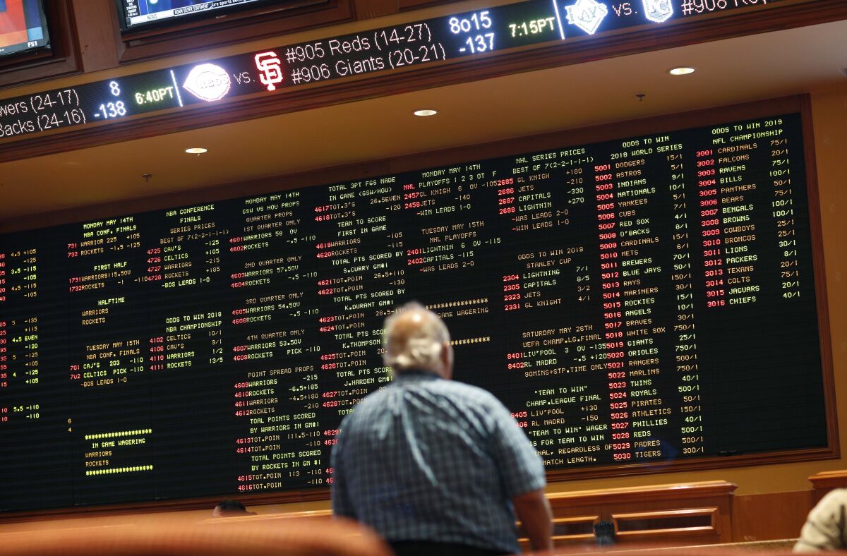 FILE - In this May 14, 2018 file photo, betting odds are displayed on a board in the sports book at a hotel casino in Las Vegas. A former minor league pitcher was the ringleader of an illegal sports betting operation in California that included current and former pro athletes, federal prosecutors said. Wayne Nix agreed to plead guilty to conspiring to run an illegal gambling operation, Thursday, March 31, 2022 (AP Photo/John Locher, File)