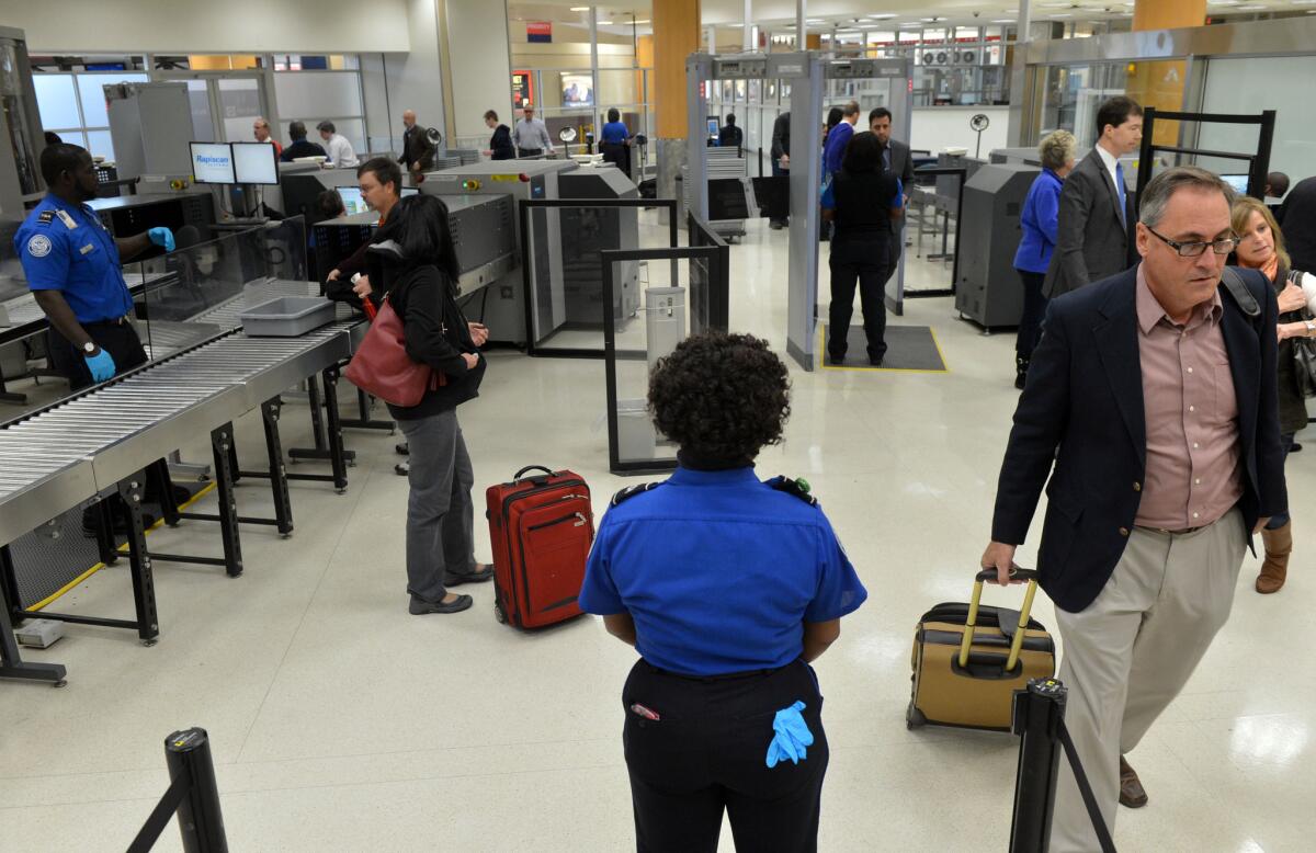 TSA agents work at a checkpoint for pre-cleared passengers at Hartsfield-Jackson Atlanta International Airport.